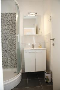a bathroom with a shower and a sink and a tub at Apartments Gabrijel in Vodice +43 photos
