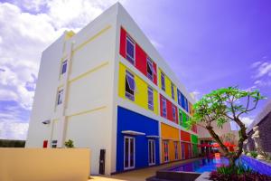 a colorful building with colorful windows at Front One Hotel Purwodadi in Purwodadi