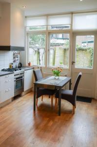 a kitchen with a table and chairs in a kitchen at Apartment Havenstraat in Delft