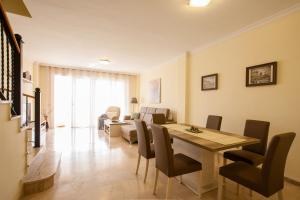 a living room with a dining room table and chairs at Residencial Playa de La Arena in Puerto de Santiago