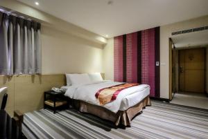 Voodi või voodid majutusasutuse Country Garden Hotel toas