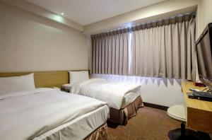 Voodi või voodid majutusasutuse Country Garden Hotel toas