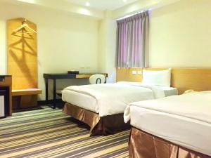 Voodi või voodid majutusasutuse Country Garden Hotel toas