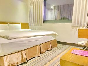 Voodi või voodid majutusasutuse Country Garden Hotel toas