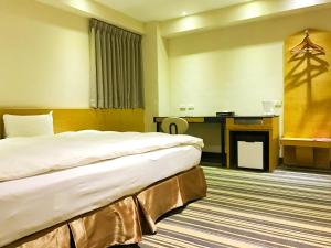Voodi või voodid majutusasutuse Country Garden Hotel toas