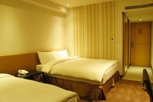 Voodi või voodid majutusasutuse Country Garden Hotel toas