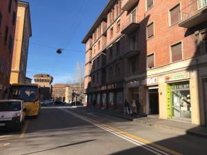 a city street with people standing on the side of a building at Antica Bologna in Bologna
