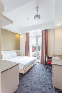 Ein Bett oder Betten in einem Zimmer der Unterkunft Scott Hotel KL Sentral