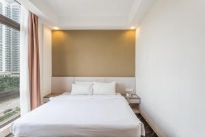 Ein Bett oder Betten in einem Zimmer der Unterkunft Scott Hotel KL Sentral