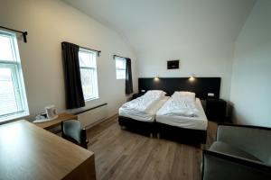 מיטה או מיטות בחדר ב-Dæli Guesthouse