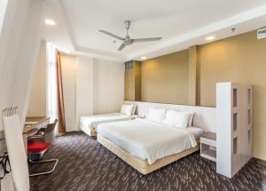 Ein Bett oder Betten in einem Zimmer der Unterkunft Scott Hotel KL Sentral