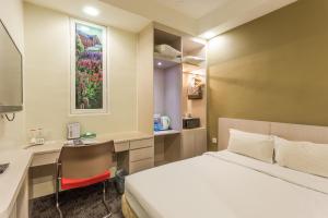 Ein Bett oder Betten in einem Zimmer der Unterkunft Scott Hotel KL Sentral