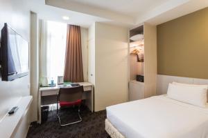 Ein Bett oder Betten in einem Zimmer der Unterkunft Scott Hotel KL Sentral