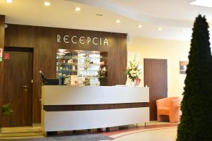 a reception area of a recceapa store with a counter at Hotel Ban&iacute;k Handlov&aacute; in Handlov&aacute;