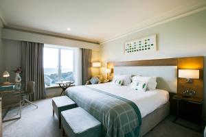Habitación de hotel con cama grande y ventana en Portmarnock Resort & Jameson Golf Links, en Portmarnock