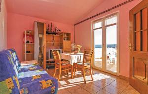 a living room with a table and chairs and a window at Apartments ZZ in Posedarje