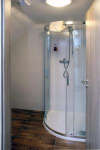 a bathroom with a shower with a glass enclosure at Apartments Stein in Boží Dar