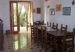 a dining room with a wooden table and chairs at Villa Franca in Marinella di Selinunte
