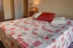 a bedroom with a bed with a quilt on it at B&B Doria Valle Maira in Roccabruna