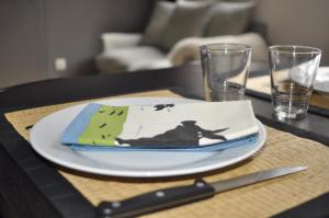 a table with a white plate and a knife and fork at Strasbourg Centre Epine in Strasbourg