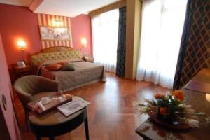 A bed or beds in a room at Palazzo Rosenthal Vesuview Hotel & Resort