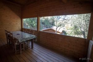 a room with a table and chairs on a porch at Résidence Marina Livia in Serriera +10 photos
