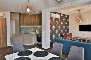a kitchen and living room with a table and chairs at Black Sea Royal Villa in Rogachevo