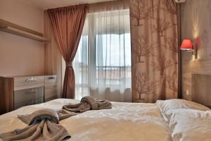 a bedroom with a bed with a towel on it at Black Sea Royal Villa in Rogachevo +34 photos