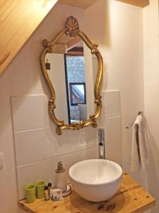 a bathroom with a sink and a mirror on the wall at Aquarelle in Sainte-Maure-de-Touraine