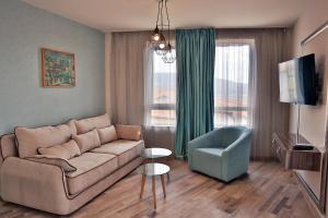 a living room with a couch and a chair at Black Sea Royal Villa in Rogachevo