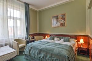 a bedroom with a bed and a painting on the wall at Hotel Hastal Prague Old Town in Prague