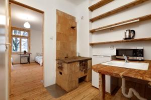 a kitchen with a sink and a counter with a microwave at Riga Academic Guest House in Riga