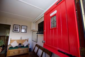 a red door in a room with a table at Erinona Chalet in Kesh