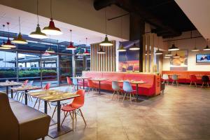 a restaurant with tables, chairs, and tables in it at Ibis Istanbul Zeytinburnu in Istanbul