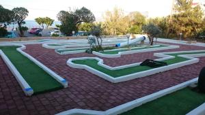 a park with a bunch of fake golf courses at Amazones Villas Apartments in Stalís