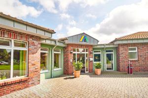 a brick building with a letter a on it at Jugendherberge Jever in Jever