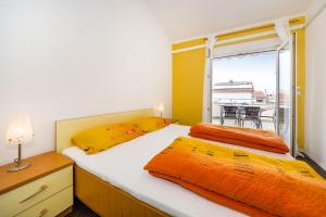 two beds in a small room with a window at Apartments Villa Rotim in Zadar +63 photos