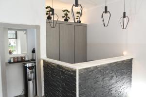 a bar in a kitchen with a brick wall at The Omega Hotel in London