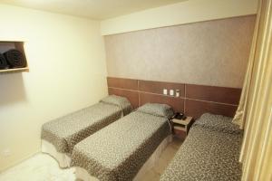 Postel nebo postele na pokoji v ubytování Hotel Real