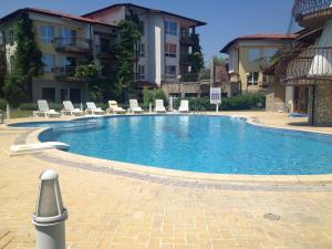 a large swimming pool in front of a building at Black Sea Royal Villa in Rogachevo