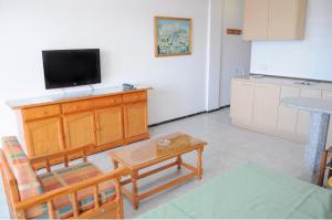 a living room with a flat screen tv on a cabinet at Apartamentos Roque Nublo in Playa del Ingles