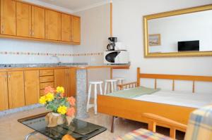 a kitchen with a bed and a table in a room at Apartamentos Roque Nublo in Playa del Ingles