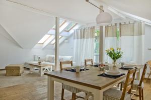 a dining room with a wooden table and chairs at Imperial Apartments - Nautica in Sopot