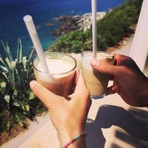 two people holding drinks in their hands on a balcony at Villa Terasa in Molunat