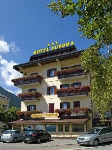 a hotel with a sign on top of it at Hotel Aurora srls in Auronzo di Cadore