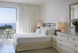 Postel nebo postele na pokoji v ubytování Amarilia Hotel