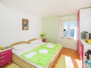 a bedroom with a large bed and a window at Apartments Adria in Petrovac na Moru
