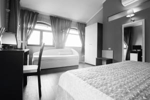 a black and white bedroom with a bed and a window at Il Fortino in Celano