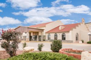 a church building with a red roof at Days Inn by Wyndham Lamar in Lamar