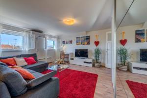 a living room with a couch and a red rug at Apartment Bačvice Holiday in Split